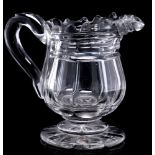A mid 19th Century heavy cut-glass cream jug: on star-cut foot, circa 1840, 14cm.