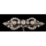 A Victorian white metal and diamond mounted bar brooch: of pierced design set with old,