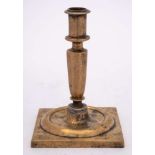 A late 17th/early 18th Century Spanish brass candlestick: with plain cylindrical nozzle on an