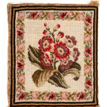 A 19th Century woolwork panel: depicting a floral spray enclosed by a Berlin work foliate border,
