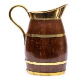 An oak and brass bound pitcher:, of barrel shape with brass scroll handle.