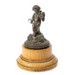 A 19th Century bronze study of Cupid: on a domed base with female mask decoration,