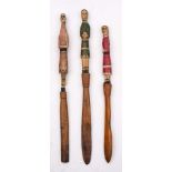 Three folk art carved wood stick dolls, possibly American: with polychrome decoration,