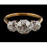 A diamond three-stone diamond ring: with round old brilliant-cut diamonds in curtain-claw settings,