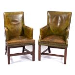 A pair of Georgian mahogany and leather club armchairs:, of square form,