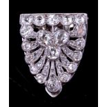 A diamond clip brooch: of stylised anthemion shell design millegrain and pave-set with round old