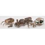 A silver filigree model of a miniature steam locomotive and tender, unmarked: 13cm long,