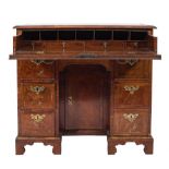An early 18th Century walnut and cross and feather banded secretaire kneehole desk:,
