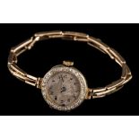 A lady's 18ct gold and diamond-set wristwatch: the circular dial with Arabic numerals,