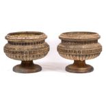 A pair of Edwardian stoneware circular pedestal garden urns:, the bodies with moulded top,