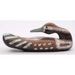 A carved wood and polychrome decorated decoy Pintail duck: overall length 35cm.