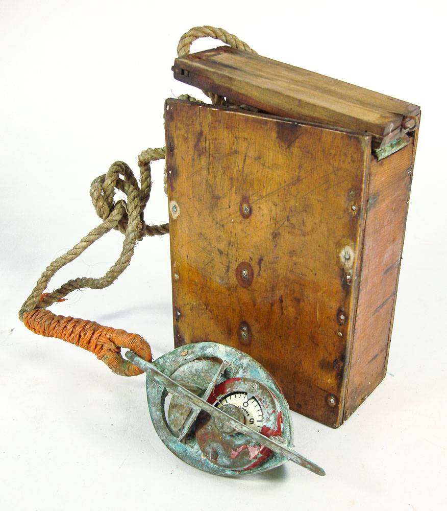 A Walker's Harpoon II Depth Finder: with lead weight in original wooden case with remains of paper