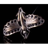 An early 20th century silver plated hat pin in the form of a flying cricket,