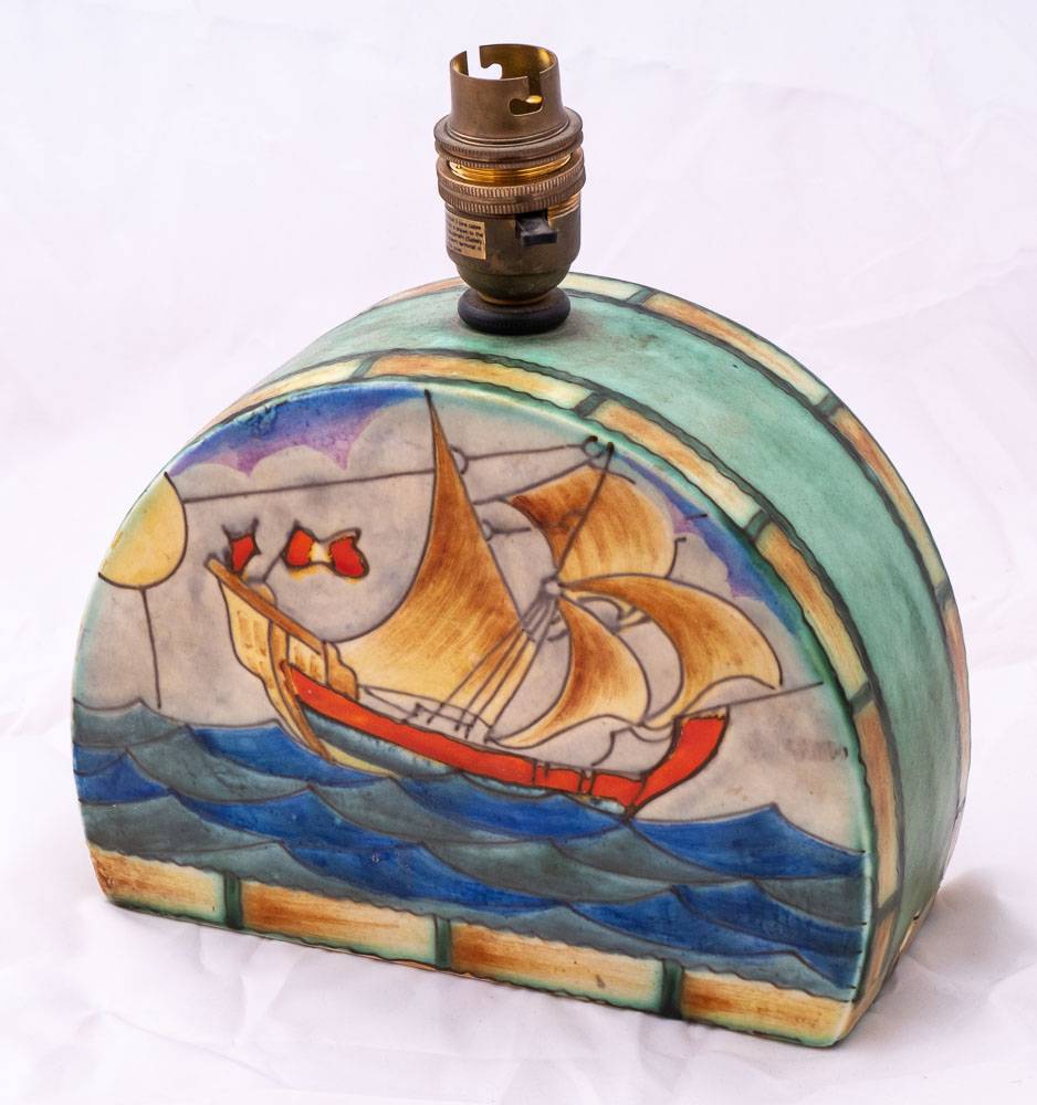 An Art Deco Crown Devon Fieldings half moon table lamp with galleon and light house decoration:,