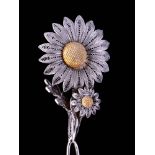 An early 20th century white metal filigree hat pin in the form of an articulated daisy: on double