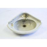 An LMS cabin earthenware corner sink: with short splashback and single tap,