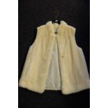 A Ladies white mink gillet: with silk lining, unsigned.