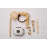 A late 19th century carved ivory dog's head whistle: together with a carved ivory seal,