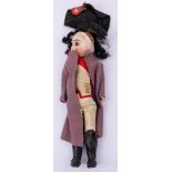 An early 20th century Continental bisque head Napoleon doll: black wig over brown glass eyes,