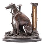 A late 19th/early 20th century bronzed metal desk thermometer: in the form of a dog seated by tree