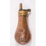 A brass and copper Colt style pistol powder flask with eagle decoration 11cm long:.
