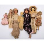 A small group of early 20th century dolls: comprising a wax head doll(damaged) two wooden peg dolls