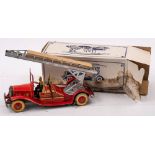 A tinplate clockwork fire engine:, with silver turntable and ladder, red lithograph printed cab,