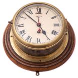 A circular brass 8-day bulkhead clock by Smiths:,