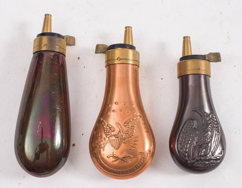 Three small reproduction copper and brass pistol powder flasks (3):