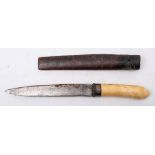 A Burmese dha dagger: the short blade over a white metal hilt and one piece ivory grip,