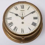 A Circular brass bulkhead clock by Astral,