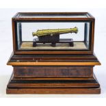 A cased mahogany and brass scale model cannon:,