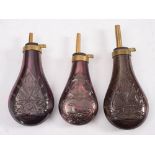 Three copper and brass reproduction powder flasks: with repousse decoration to bodies(3).