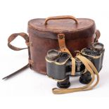 A pair of WWI military issue Prismatic binoculars in brown leather case date stamped 1916: together