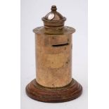 A WWI trench art money box modelled in the form of a Post box: mounted on a wooden socle,