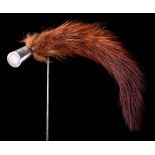 An Edwardian white metal mounted mink tail hat pin,: 17cm long.