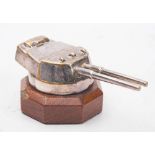 A silver plated model of a Royal Navy gun emplacement on an octagonal wooden plinth:, 11.5cm long.