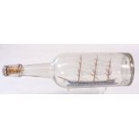 An early 20th century ship in a bottle of a waterline model of a three masted clipper: with rope