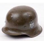 A German Model 1935 pattern steel helmet: with transfer decals, stamped '4431' to inner edge.