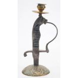 A Continental sword hilt candlestick: with brass sconce and mounted on a domed brass base,