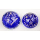 Two Masonic theme glass paperweights: decorated in blue and gilt, one with floral cane border,