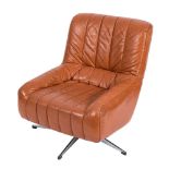 A tan leather and chrome swivel chair, circa 1970:.