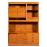 A Danish teak dresser: with an arrangement of open shelves and cupboards with sliding doors,