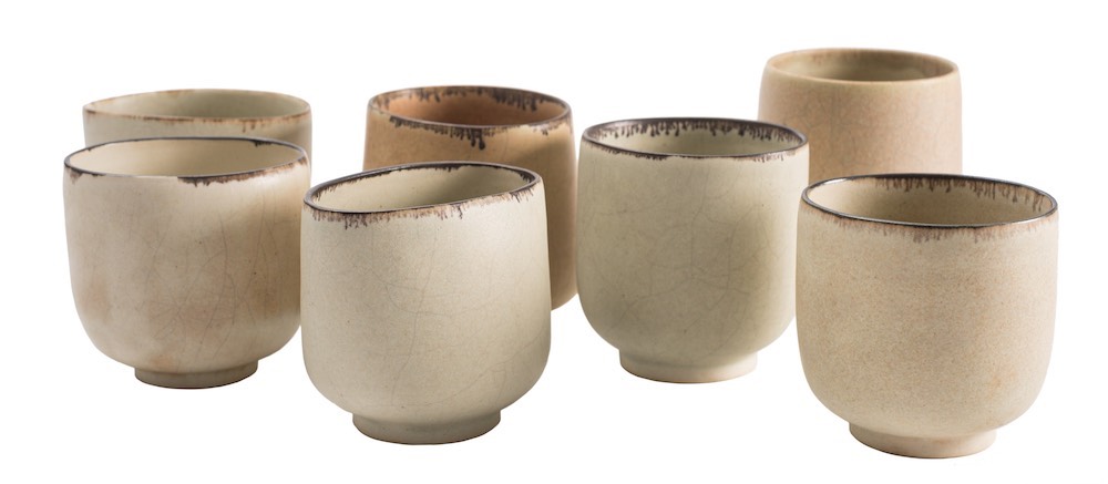 *Val Barry [1937-2018] seven porcelain cups: of compressed circular form with stained rims on ivory