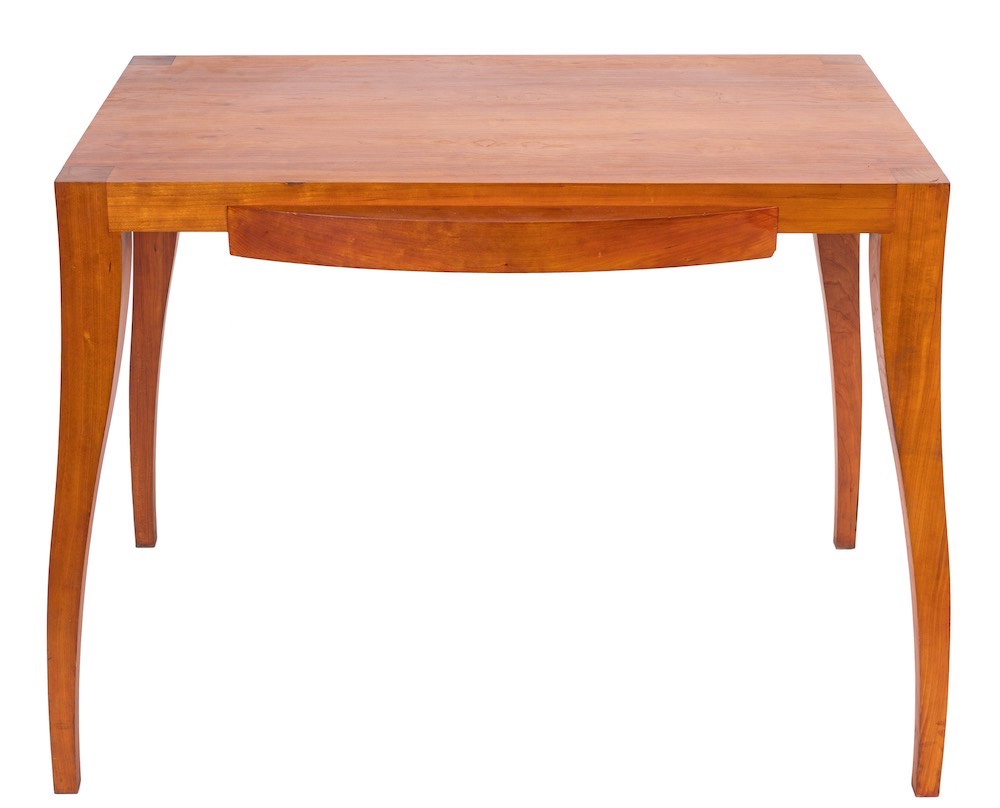 A late 20th Century cherry wood desk by Tracy Byles: the plain rectangular top with single bowfront
