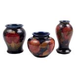 Three Moorcroft pottery small vases: two of baluster form and one squat globular example each