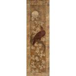 A Chinese silkwork picture: depicting a bird perched amongst flowering shrubs enclosed by a woven