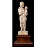 A carved ivory figure of an Indian lady with child: dressed in traditional costume and mounted on a
