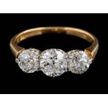 An 18ct gold and diamond three-stone ring: with round old brilliant-cut diamonds approximately 0.