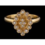 A diamond mounted oval cluster ring: set with round, brilliant-cut diamonds, ring size M.